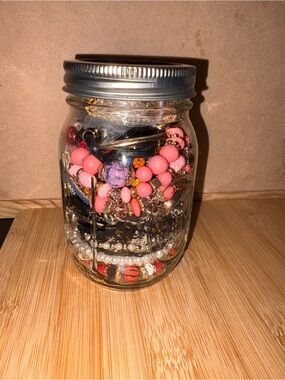 Mason Jar filled with different types of jewelry